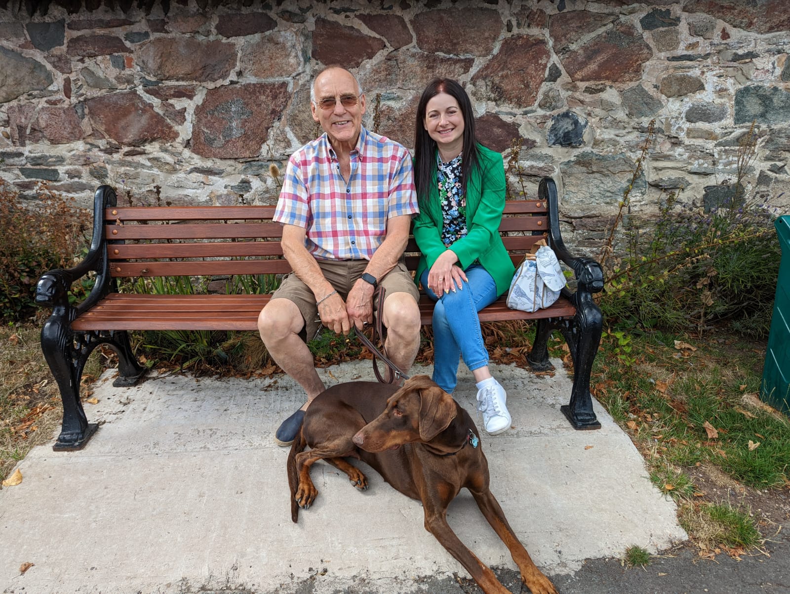 Photo of two people sitting on a bench